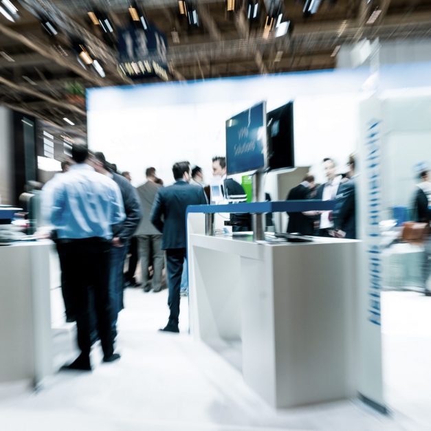 blurred business people trade fair stock photo